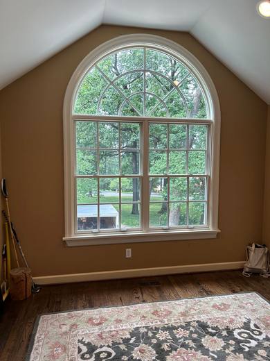 Arched window with grilles in a vaulted room, seen from inside