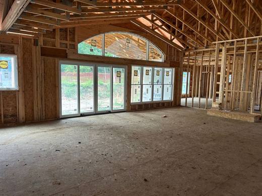 Wall of new windows with an arched transom in a home under construction